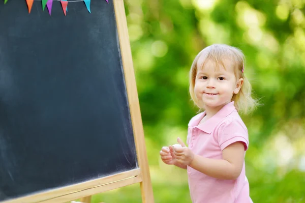 Girl drawing with   chalk Royalty Free Stock Photos