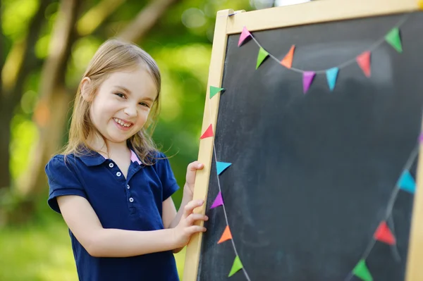 Little schoolgirl by   chalkboard Royalty Free Stock Images