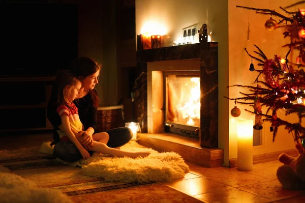 Mother and daughter near fireplace — Stock Photo, Image