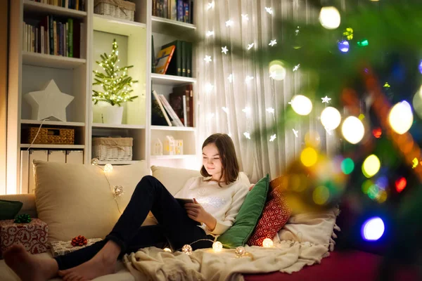 Carino Ragazza Utilizzando Tablet Casa Soggiorno Caldo Accogliente Natale Famiglia — Foto Stock