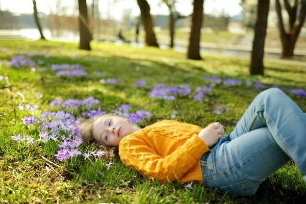 Cute Young Girl Admiring Beautiful Purple Crocus Flowers Sunny Spring — Stockfoto