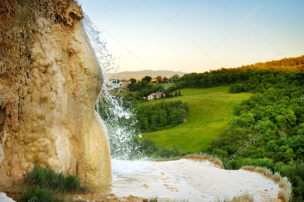 Natural swimming pool in Bagno Vignoni, with thermal spring water and calcium carbonate deposits, which form white concretions and waterfall. Geothermal pools and hot springs in Tuscany, Italy.
