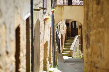 The narrow streets of Sorano, an ancient medieval hill town hanging from a tuff stone over the Lente River. Etruscan heritage. Province Grosseto, Tuscany, Italy. clipart