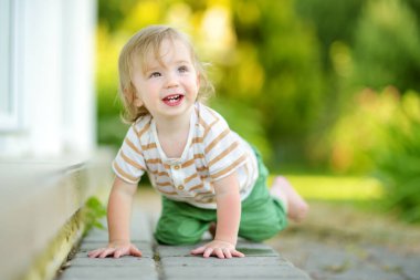 Komik çocuk güneşli yaz gününde dışarıda eğleniyor. Doğayı keşfeden çocuk. Küçük çocuklar için yaz etkinlikleri.