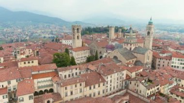 Scenic aerial view of Bergamo city northeast of Milan. Flying over Citta Alta, towns upper district, known by cobblestone streets and encircled by Venetian walls. Bergamo, Lombardy, Italy.