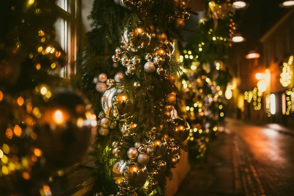 Christmas lights, trees and ornaments used as decorations at Festive season. Narrow streets of Vilnius Old Town decorated for Christmas. Celebrating Christmas and New Year in Lithuanian capital.