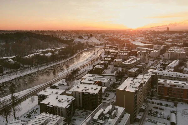 Beautiful Vilnius city panorama in winter with snow covered houses, churches and streets. Aerial evening view. Winter city scenery in Vilnius, Lithuania.