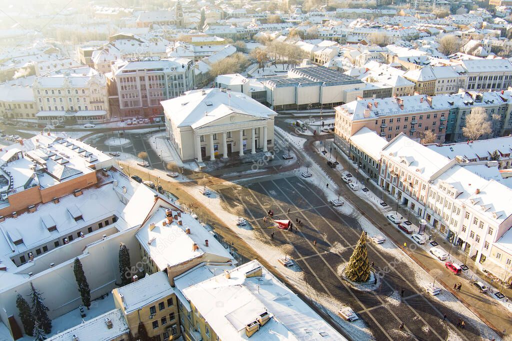 Aerial Vilnius city panorama in winter with snow covered houses, churches and streets. Town Hall square and Christmas tree. Winter city scenery in Vilnius, Lithuania.