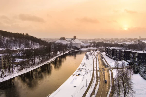 Beautiful Vilnius city panorama in winter with snow covered houses, churches and streets. Aerial sunset view. Winter city scenery in Vilnius, Lithuania.