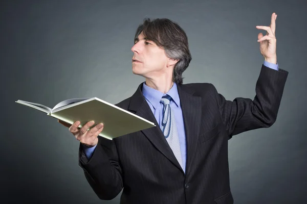 A man reads a book emotionally gesticulating. — Stock Photo, Image