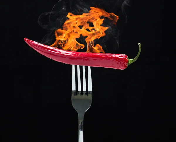 Hot chilly on fork with fire — Stock Photo, Image