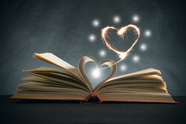 Pages of a book curved into a heart shape clipart