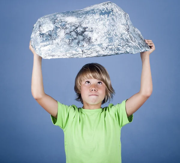 Boy holding a stone made of foil — Stock Photo, Image