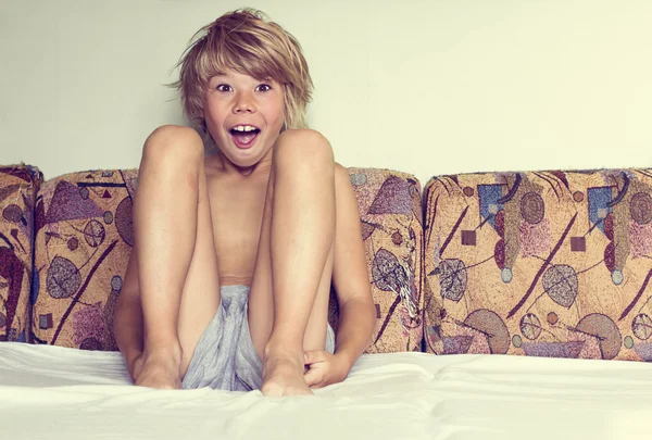 Boy sitting in the bed — Stock Photo, Image