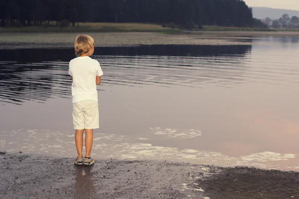 Хлопчик дивиться на річку — стокове фото