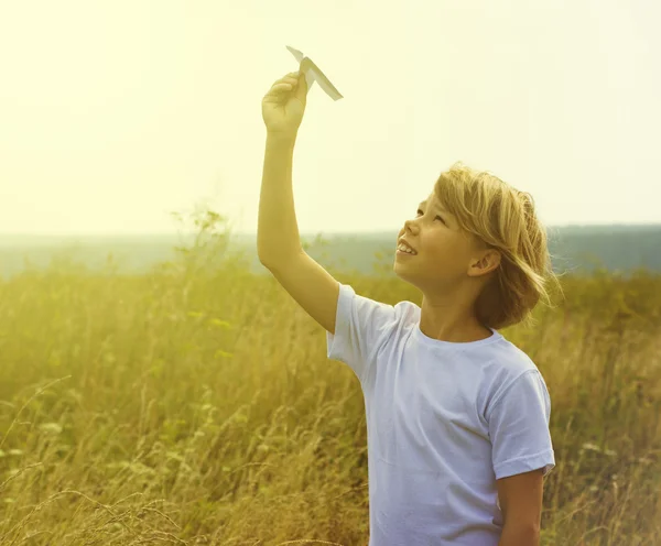 Happy kid playing with toy airplane — Stock Photo, Image
