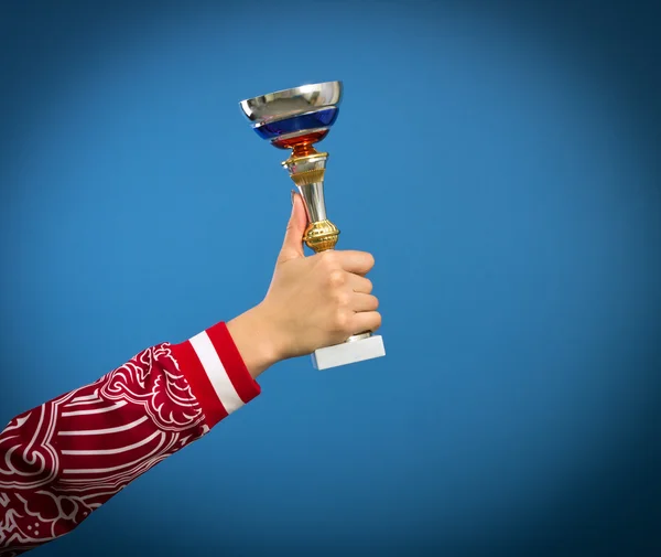 Sports cup in the hand of athlete. — Stock Photo, Image