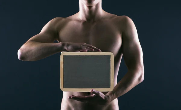 Athletic guy with a board for text — Stock Photo, Image