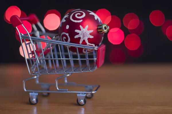 Weihnachtsbaumschmuck rote Kugel auf dem Einkaufswagen — Stockfoto