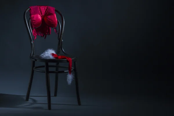 Sexy lingerie and christmas hat on chair. — Zdjęcie stockowe