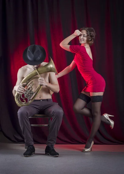 Un homme joue de la trompette et une femme danse — Photo