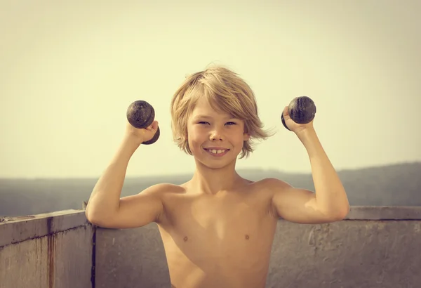 Boy with dumbbells — Stock Photo, Image