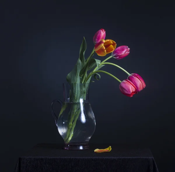 Tulipanes en una jarra de vidrio — Foto de Stock