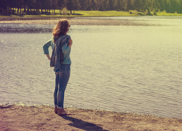 Girl standing on the river bank