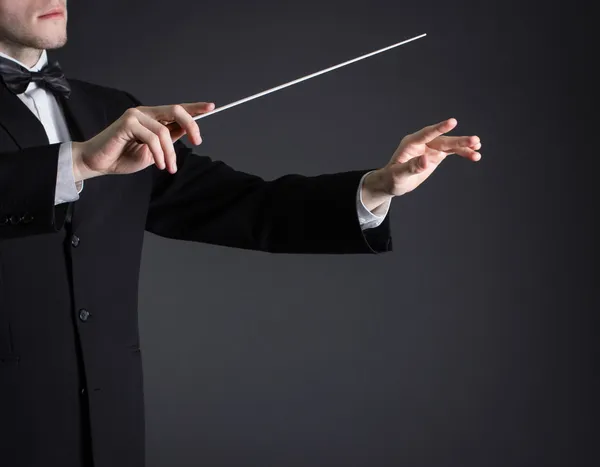 Adam orkestra yönetiyor.