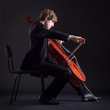 Cellist playing classical music on cello clipart