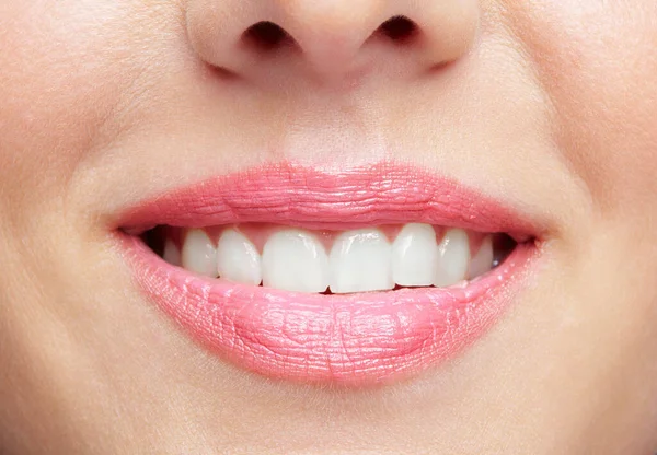 Human smiling mouth and nose. Closeup macro portrait of female part of face. Woman lips with day beauty makeup.