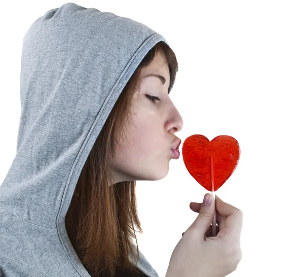 Candy red heart in the girl's lips — Stock Photo, Image