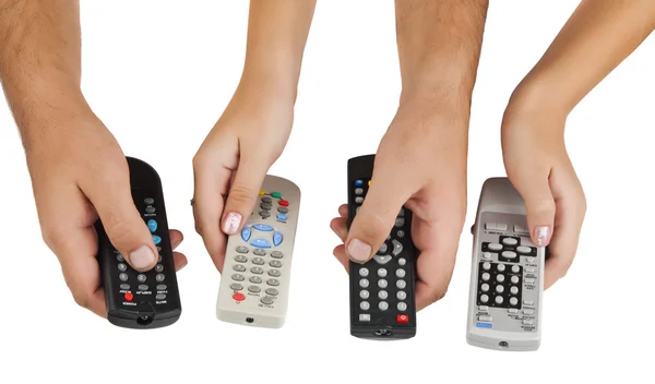 TV remote controls in their hands — Stock Photo, Image