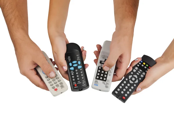 Controles remotos de TV en sus manos — Foto de Stock