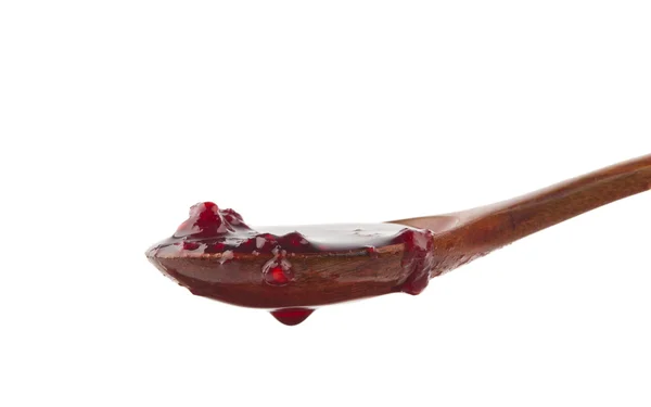 Raspberry jam in a wooden spoon — Stock Photo, Image