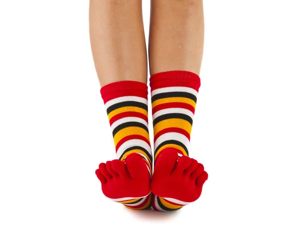 Female legs in colorful striped socks — Stock Photo, Image