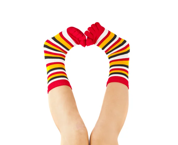 Female legs in colorful striped socks — Stock Photo, Image