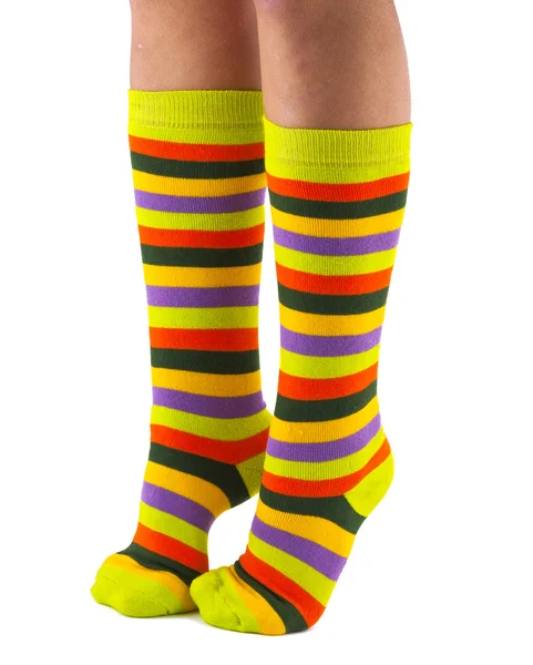 Female legs in colorful striped socks isolated — Stock Photo, Image