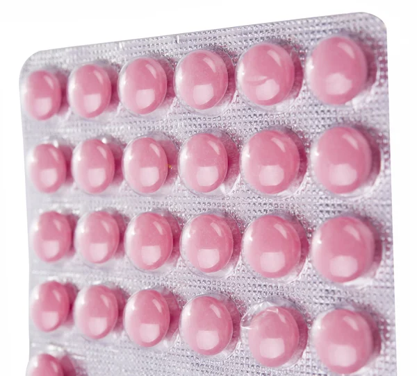 Розовые таблетки крупным планом — стоковое фото