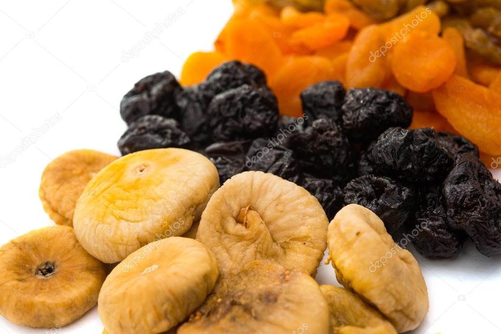 prunes, figs, dried apricots isolated on white background