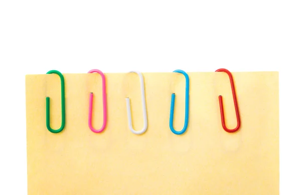 Paperclips op roze blad — Stockfoto