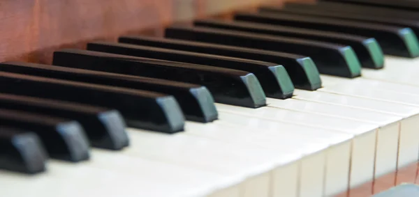 Closeup of antique piano keys and wood grain with sepia tone Stock Image