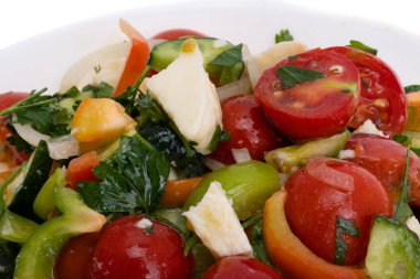 salad with tomatoes and mozzarella cheese isolated on white background