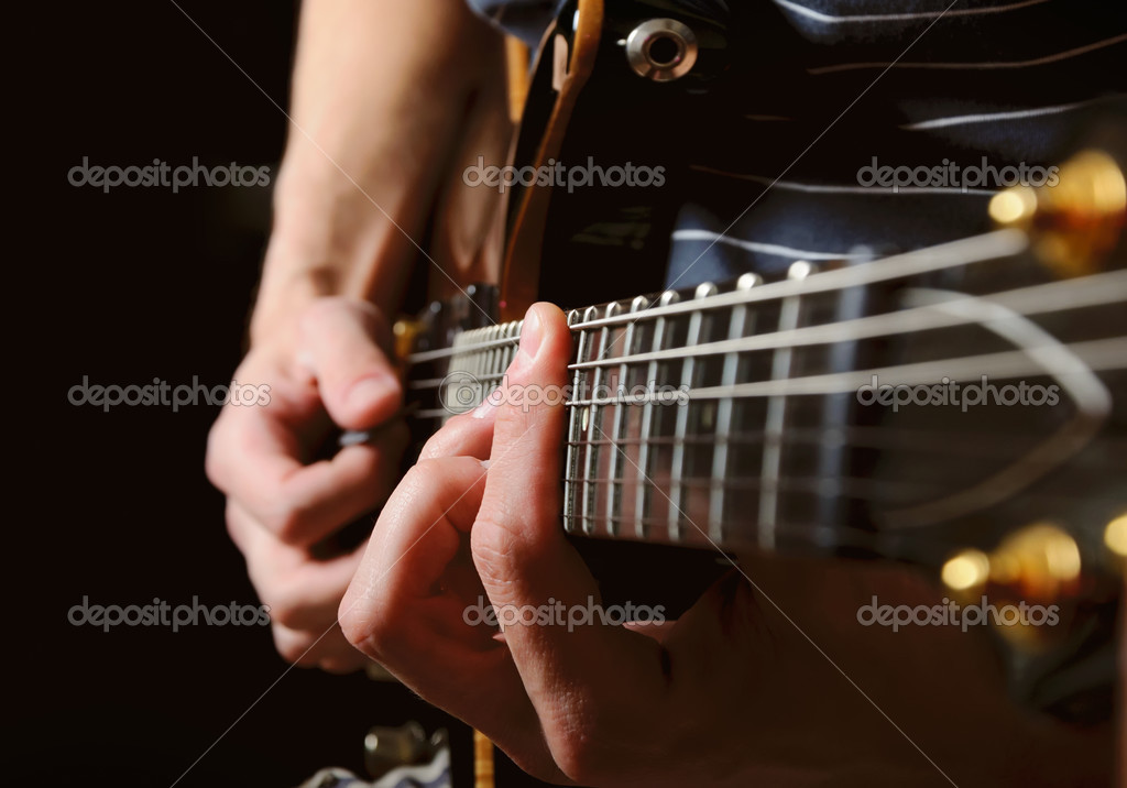 Guitarist hands playing guitar over black — Stock Photo © vkraskouski