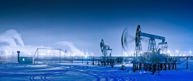 Winter night panoramic oil pumpjack. clipart