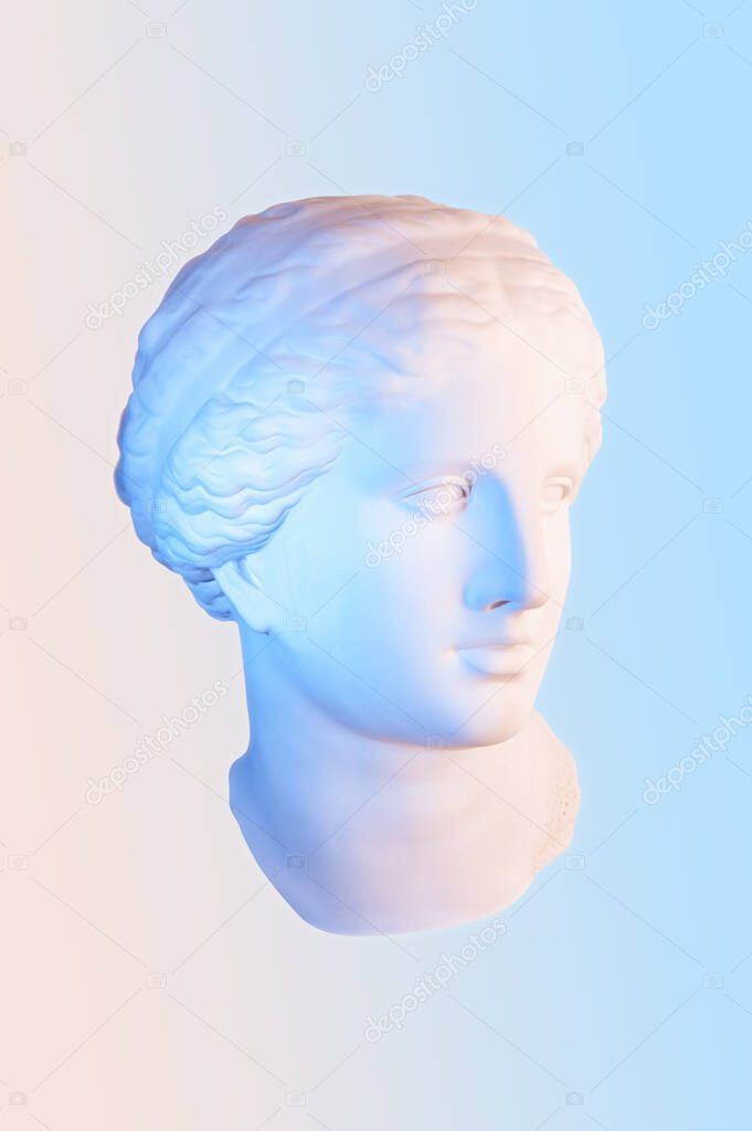Gypsum copy of the ancient statue of Venus de Milo in pastel tone for artists on pink blue background. Plaster sculpture of a womans face. Art modern poster in soft colors. Love, beauty, feminism.