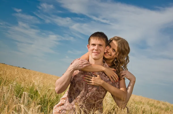 Loving couple on wheat field — Stock Photo, Image