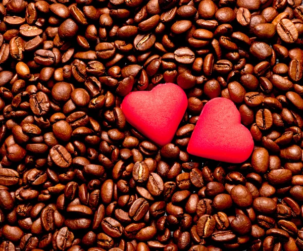 Two red hearts on coffee beans — Stock Photo, Image