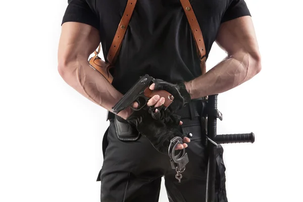 Police officer with handcuffs and gun — Stock Photo, Image