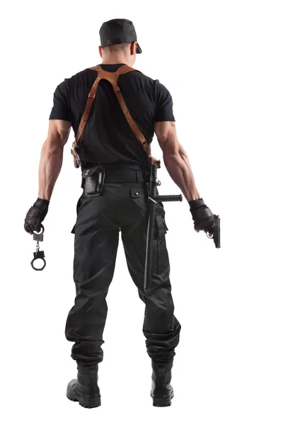 Police officer with handcuffs and gun — Stock Photo, Image